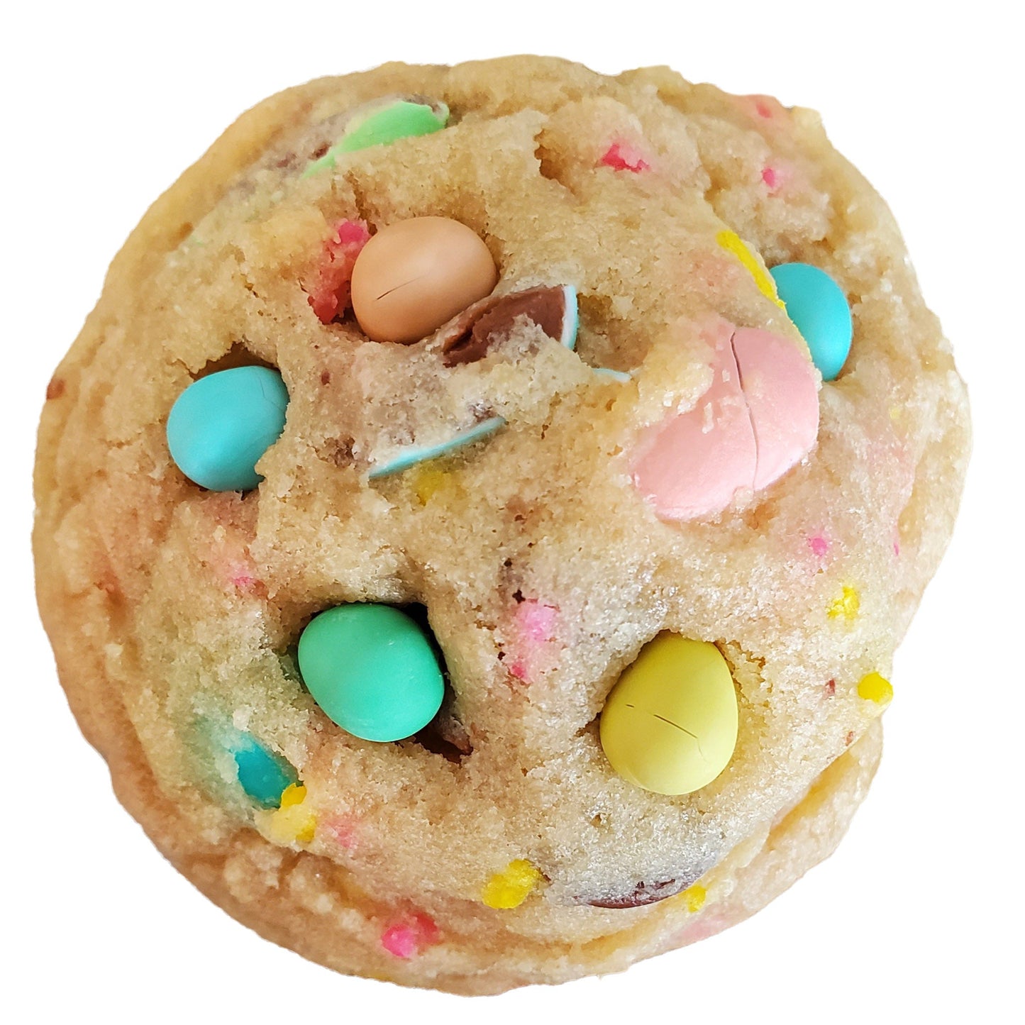 A cookie with yellow, pink, green and blue mini eggs on top.